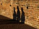 three shadows on the wall