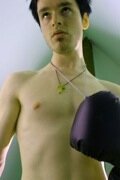 bare chested slim guy with boxing glove