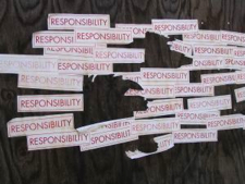 pieces of paper with responsibility typed on them