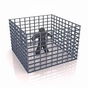 person isolated within a cage